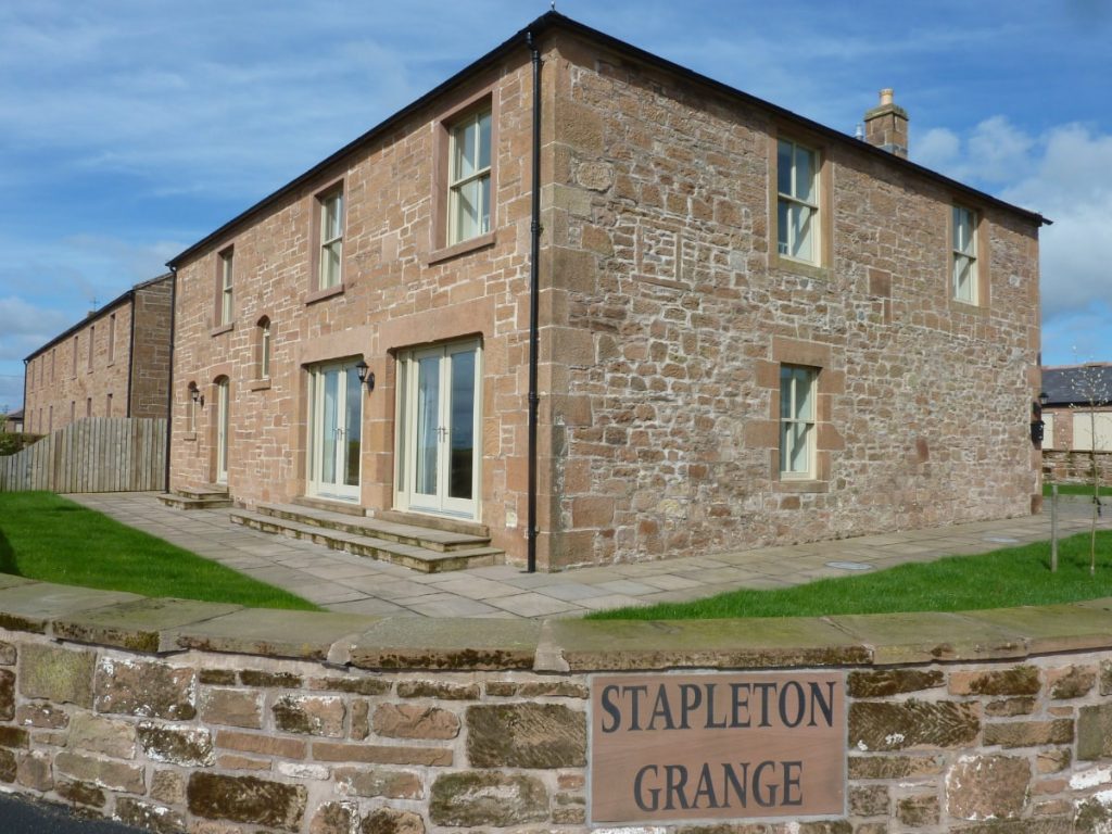 Stone house at Stapleton Grange with cream joinery and patio